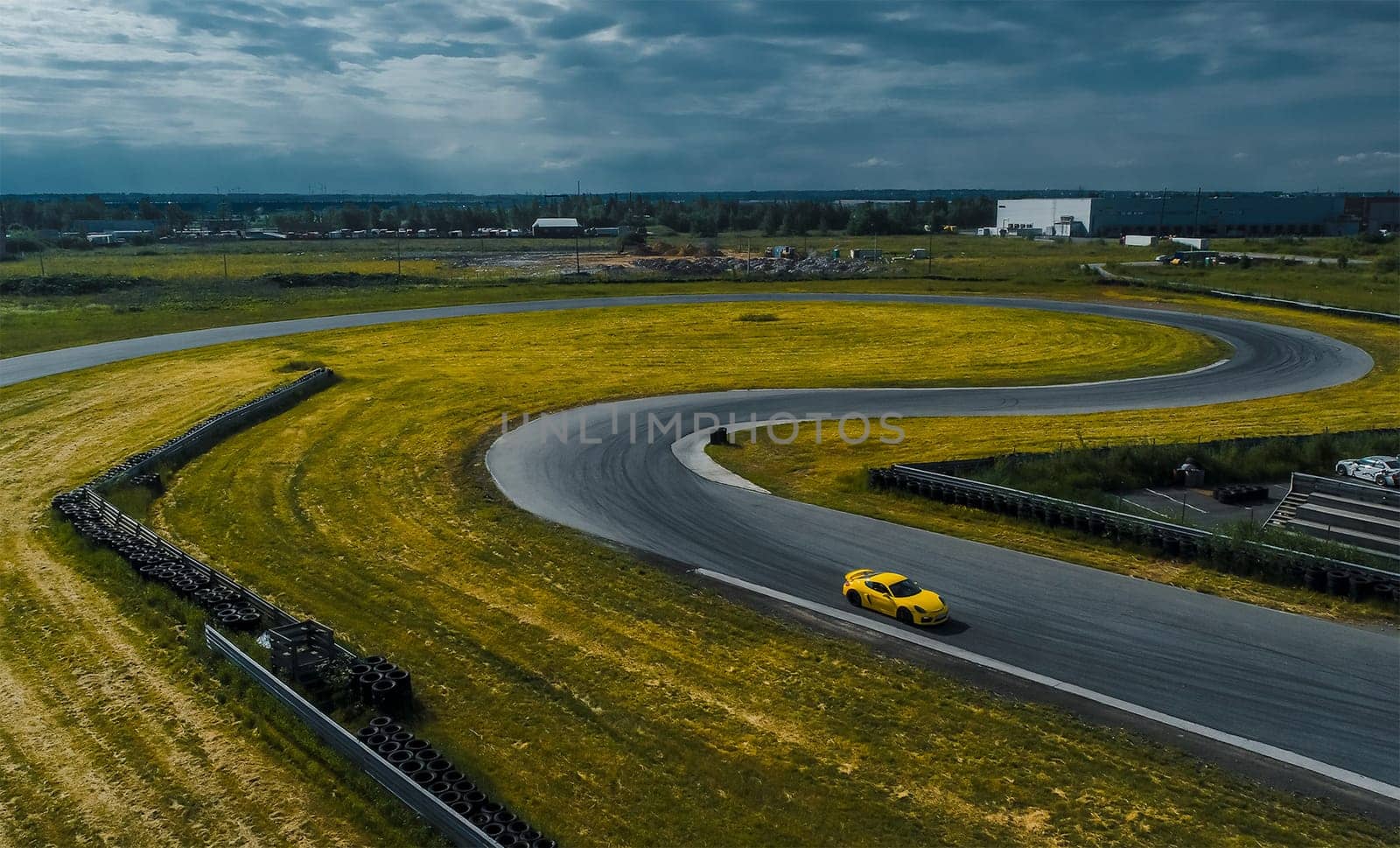 Yellow car on the race track. A section of the race track.