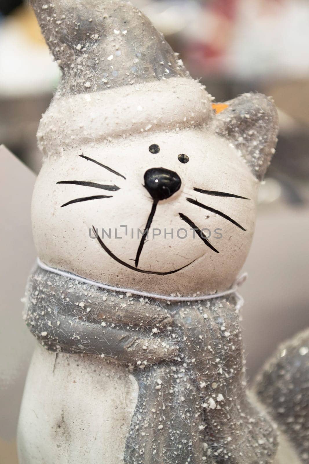 Ceramic cat with a cute Christmas hat. Vertical image