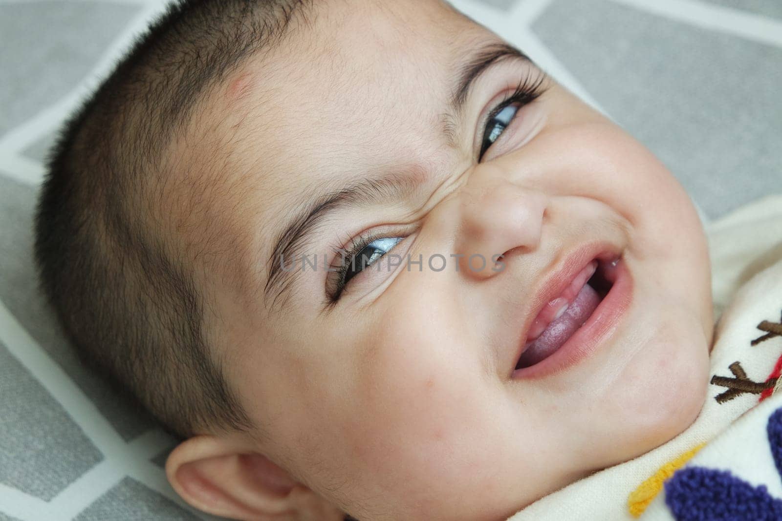 Baby girl with lovely face, big eyes and cute face gesture. Toddler baby making sweet activities