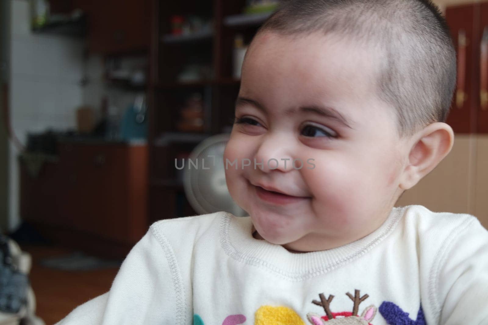 Baby girl with lovely face, big eyes and cute face gesture. Toddler baby making sweet activities