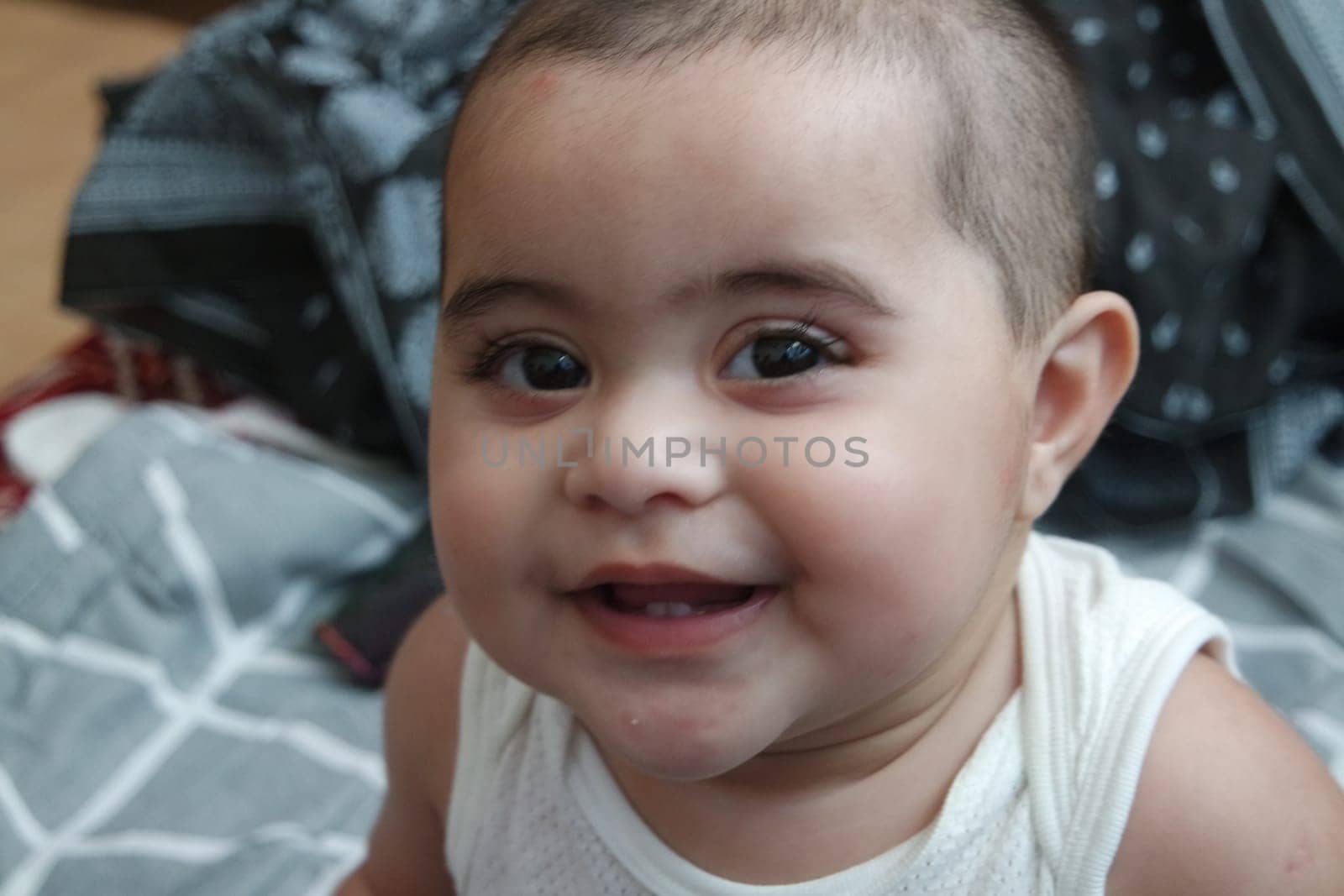 Baby girl with lovely face, big eyes and cute face gesture. Toddler baby making sweet activities