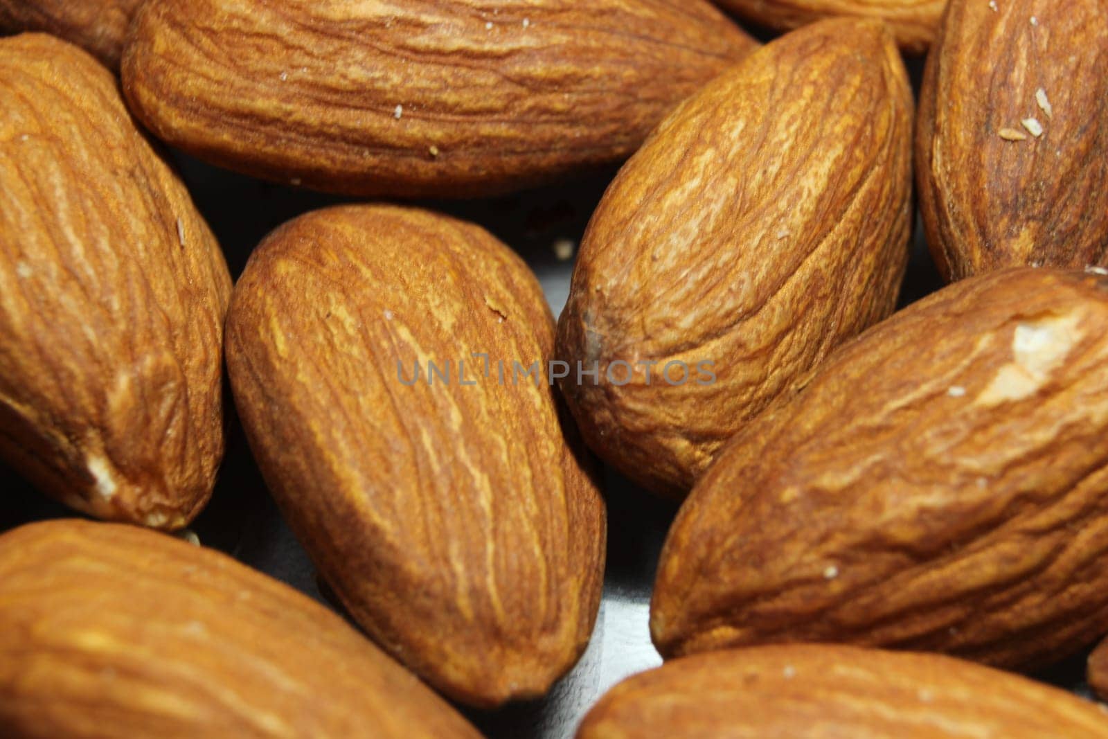 Fruit background of a pile of peeled almond nuts. Composition from almond nuts background - macro photograph of almond nuts