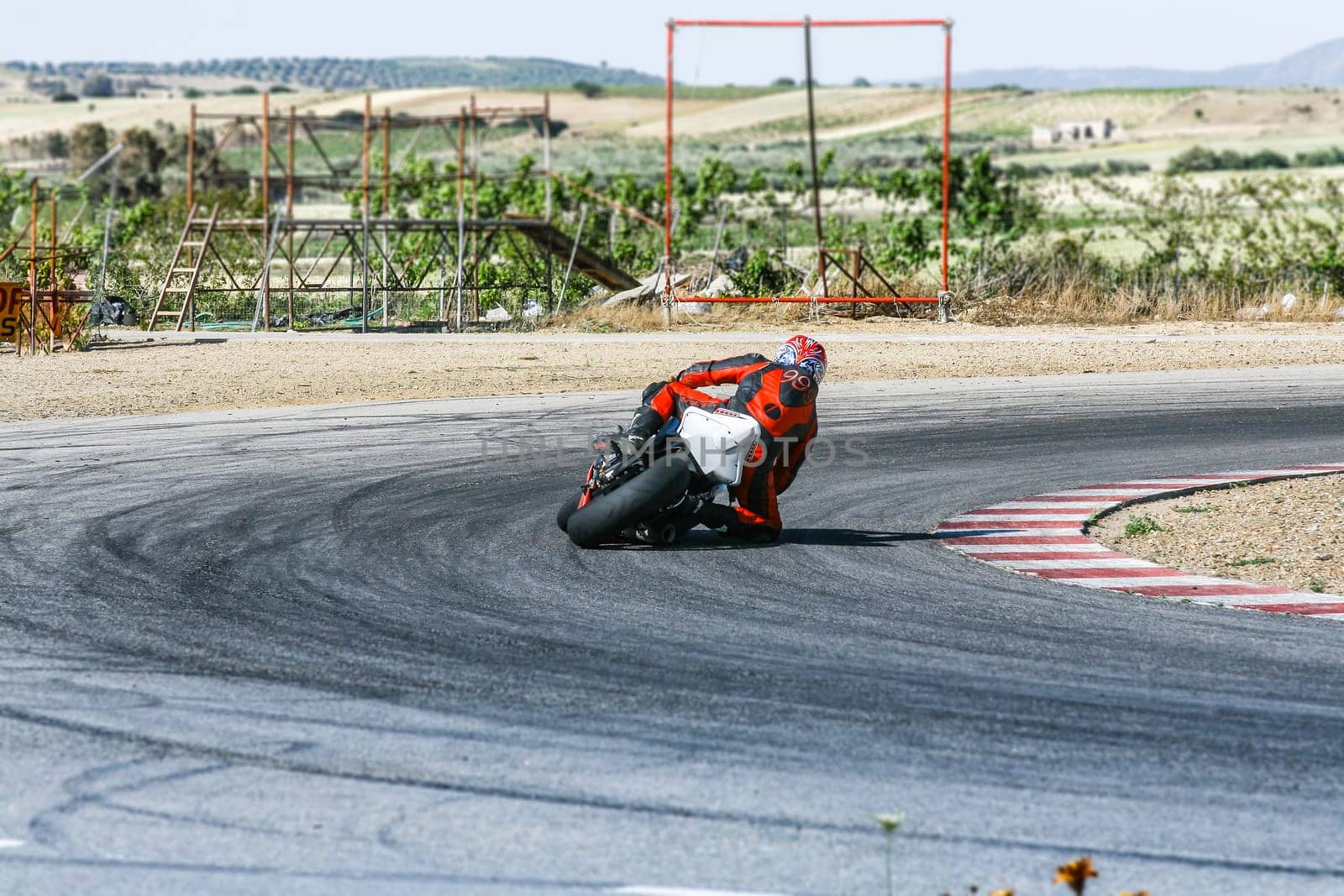 Curve fast right. Particular of a biker in Running Track.