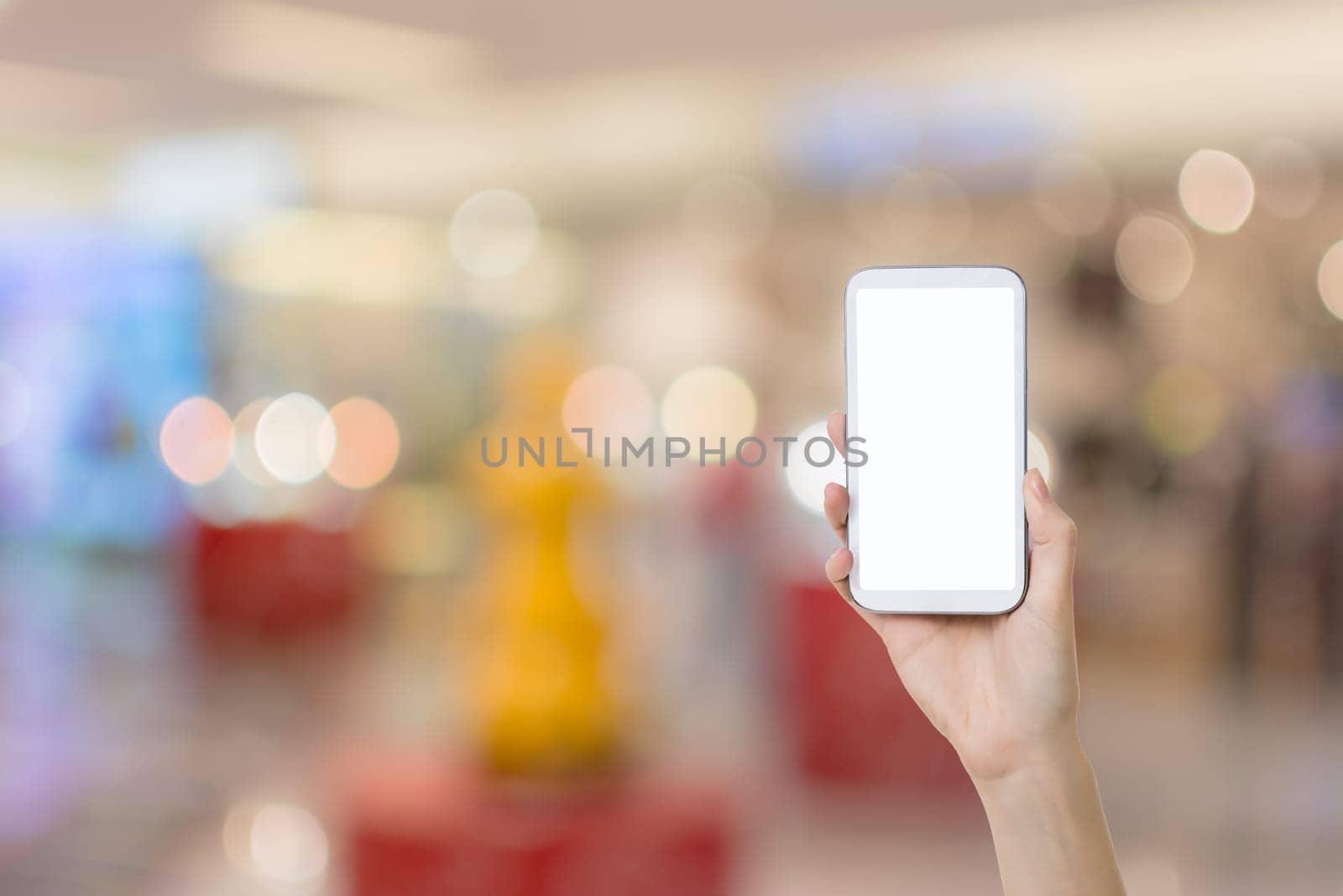 Using smartphone in a market or department store, closeup image.