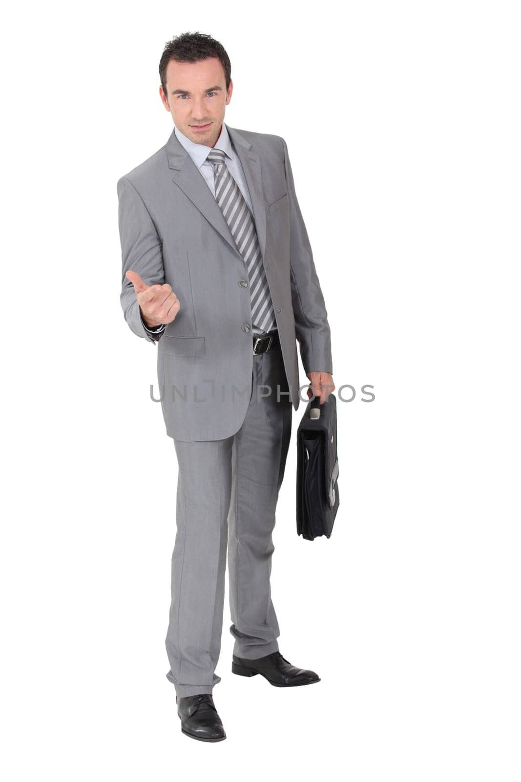 Businessman beckoning in a studio