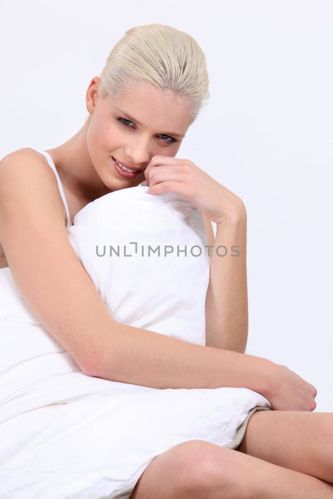 Woman sat covered by duvet