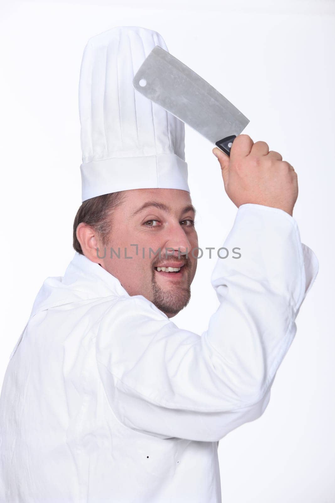 Chef in uniform wielding a cleaver