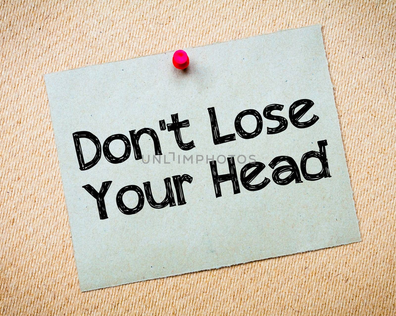 Recycled paper note pinned on cork board.Don' t Postpone Message. Motivational Concept Image