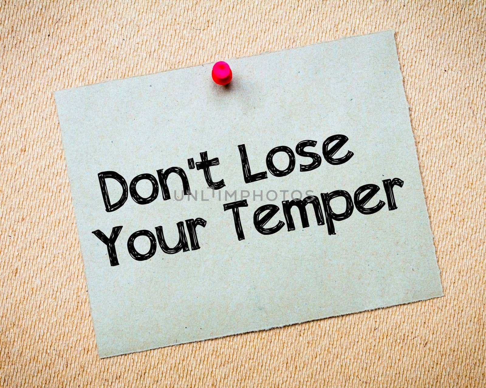 Recycled paper note pinned on cork board.Don' t Postpone Message. Motivational Concept Image