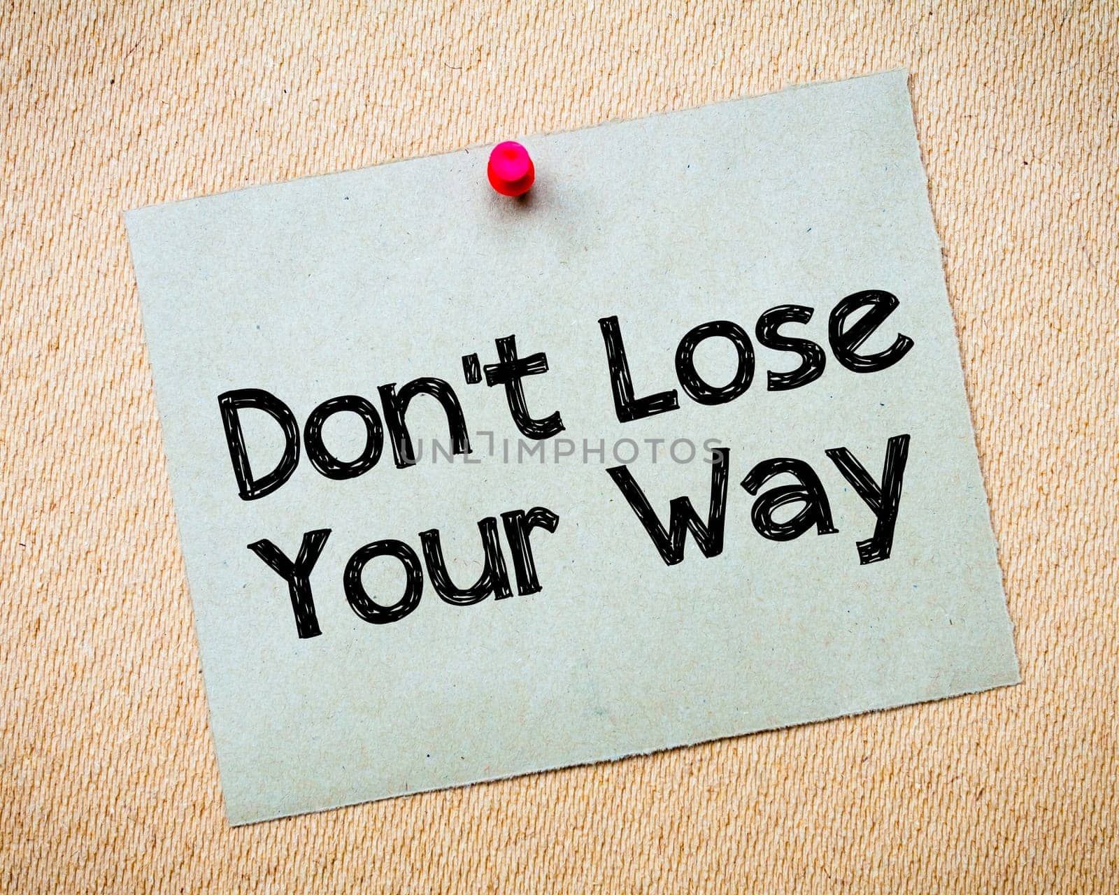 Recycled paper note pinned on cork board.Don' t Postpone Message. Motivational Concept Image