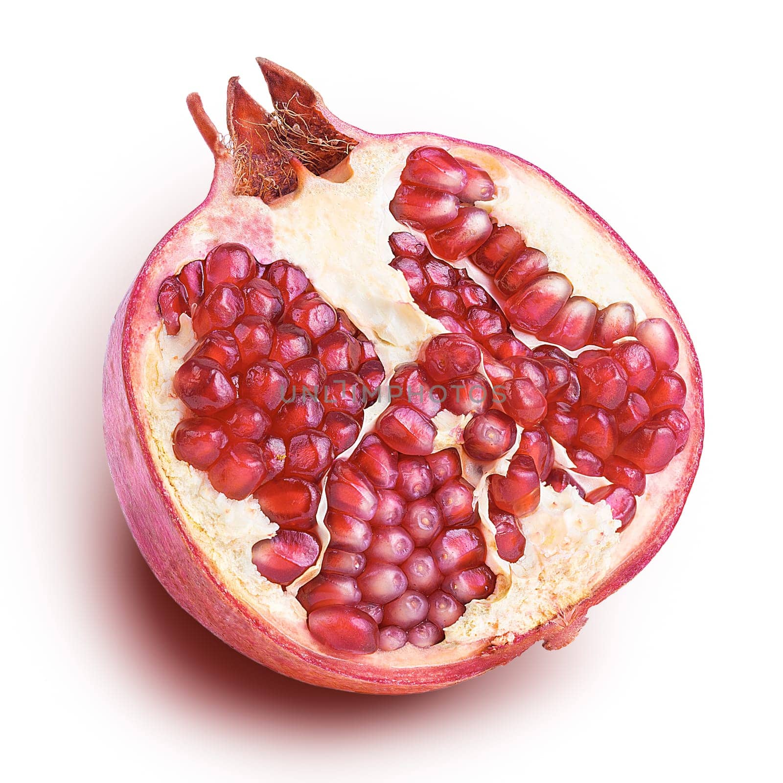 pomegranate isolated half on a white background close up with shadow.