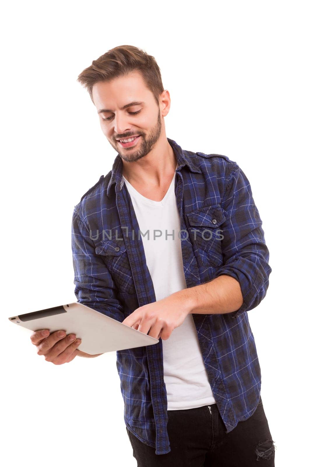 Handsome man relaxing with a tablet computer