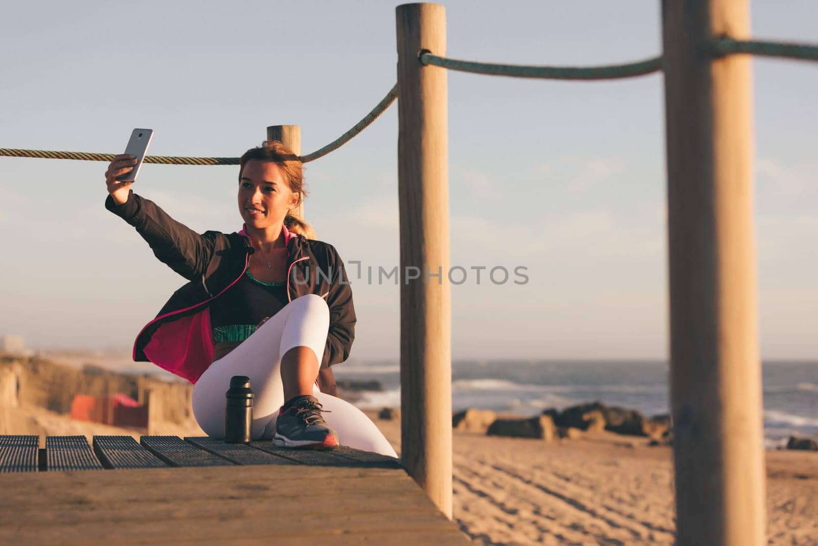 Beautiful young chinese woman taking a break from her workout