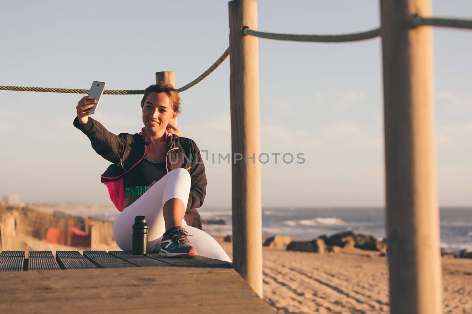 Beautiful young chinese woman taking a break from her workout