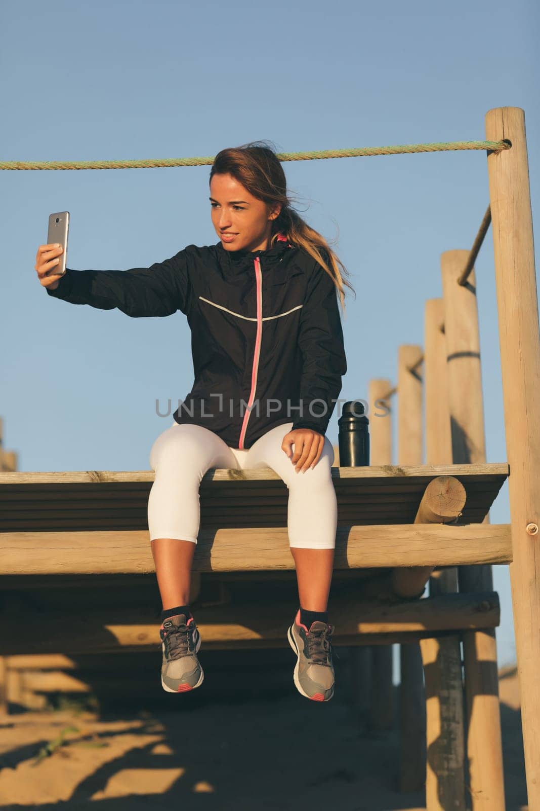 Beautiful young chinese woman taking a break from her workout