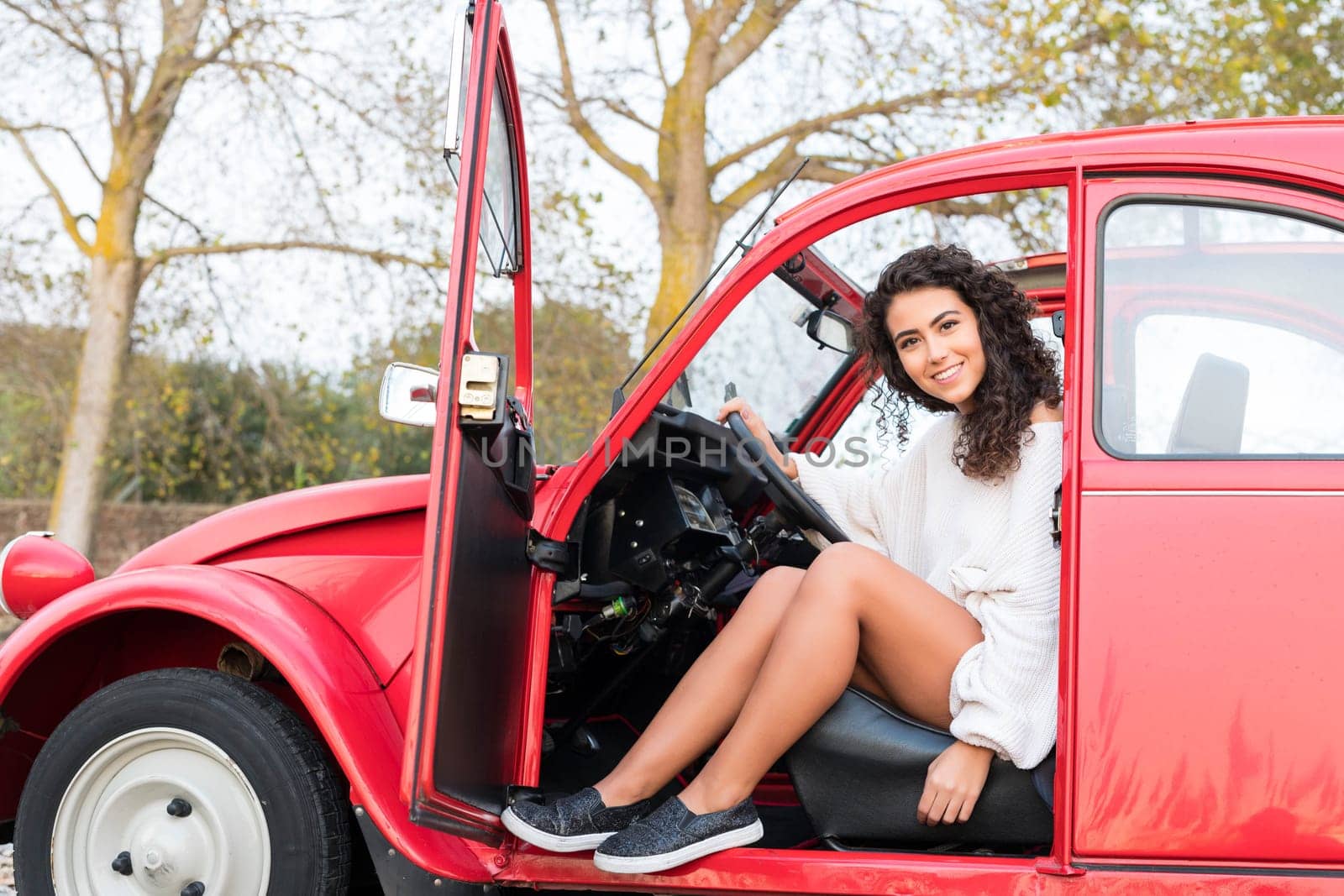 Woman going on a roadtrip in her convertible car