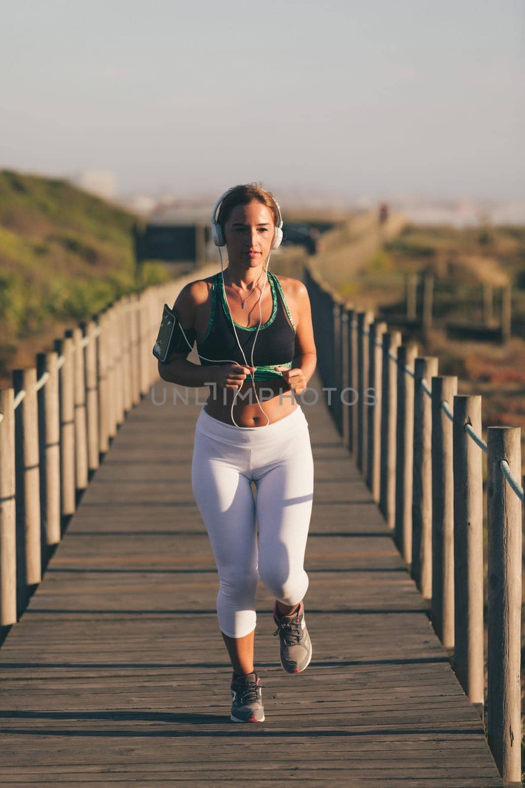 Young beautiful chinese woman exercising at the beach at sunrise/sunset