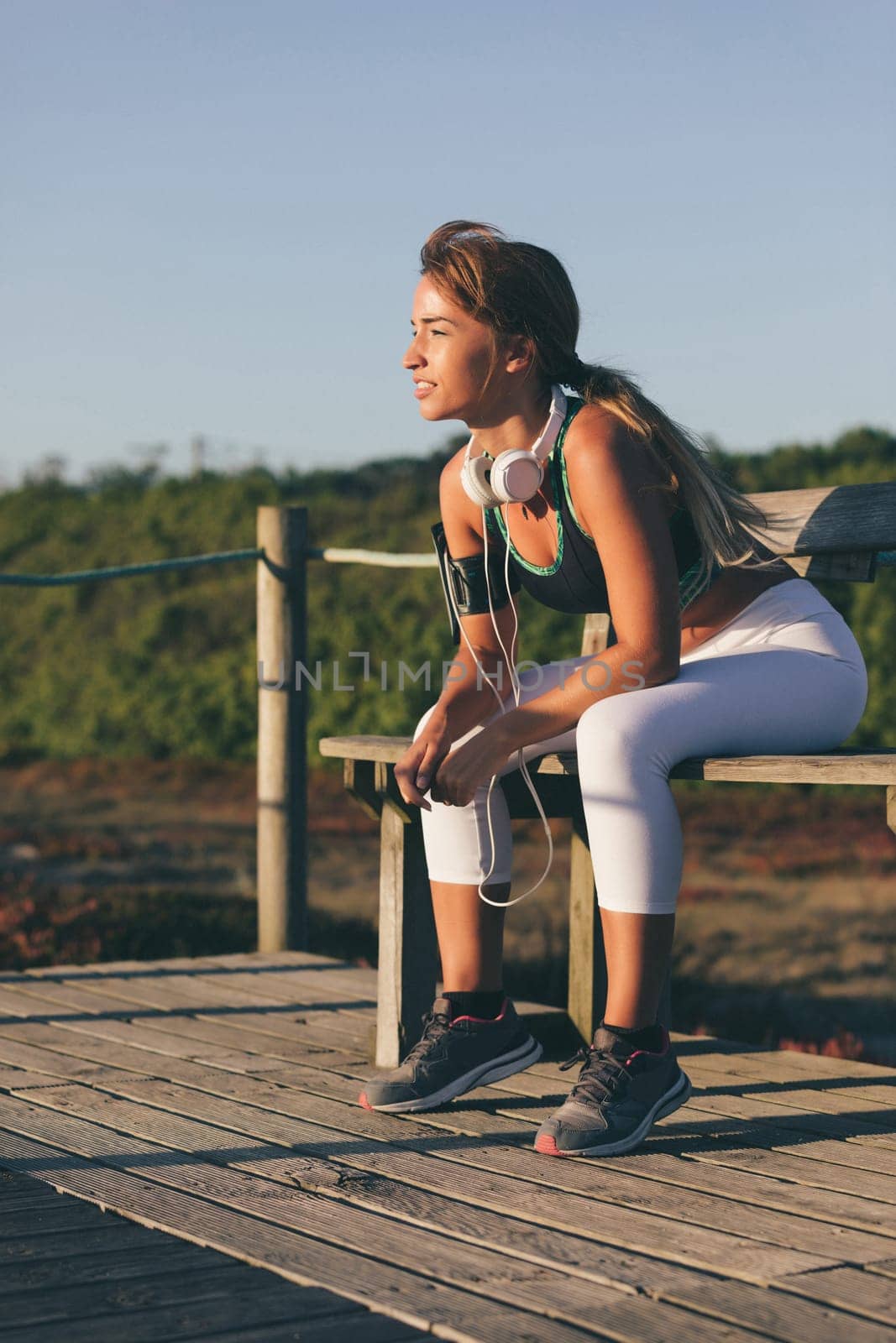 Young beautiful chinese woman exercising at the beach at sunrise/sunset
