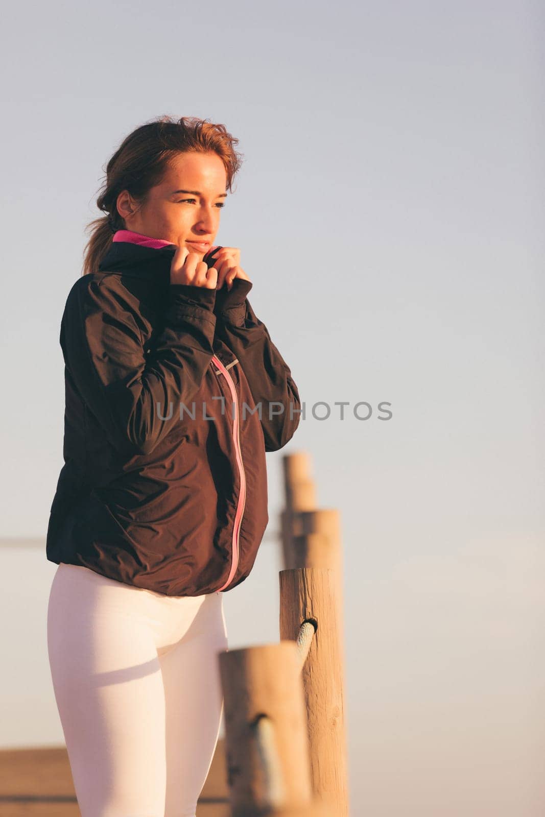 Young beautiful chinese woman exercising at the beach at sunrise/sunset