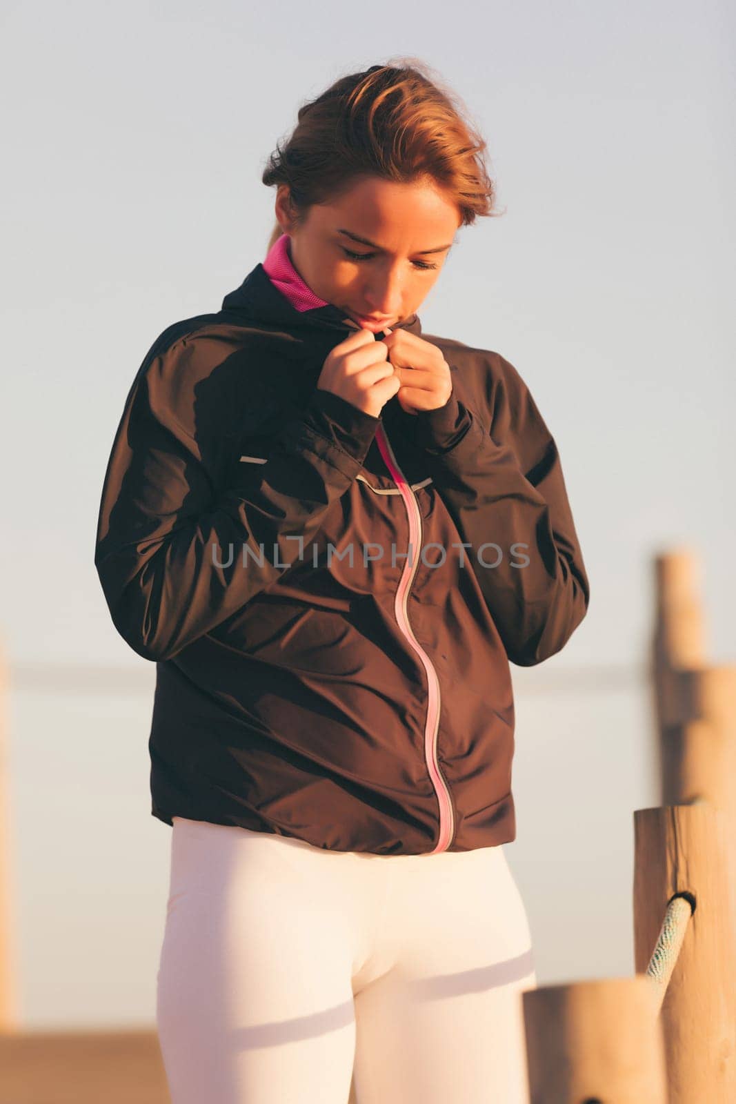 Young beautiful chinese woman exercising at the beach at sunrise/sunset