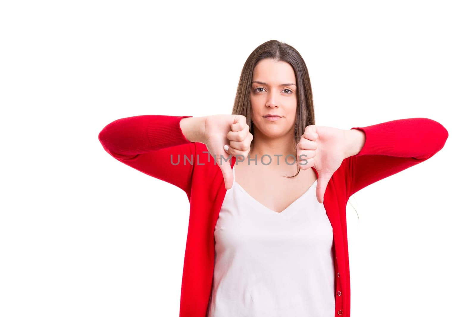 Studio shot of a young woman signaling thumbs down
