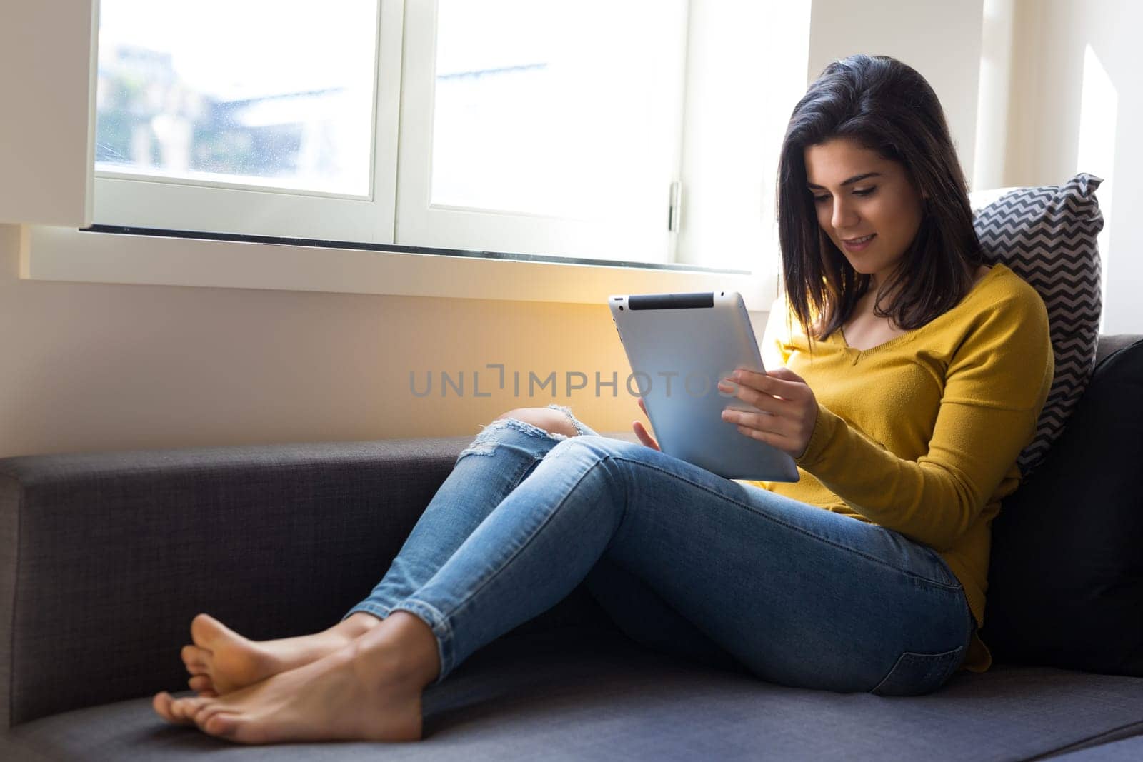 Beautiful young woman relaxing at the living room