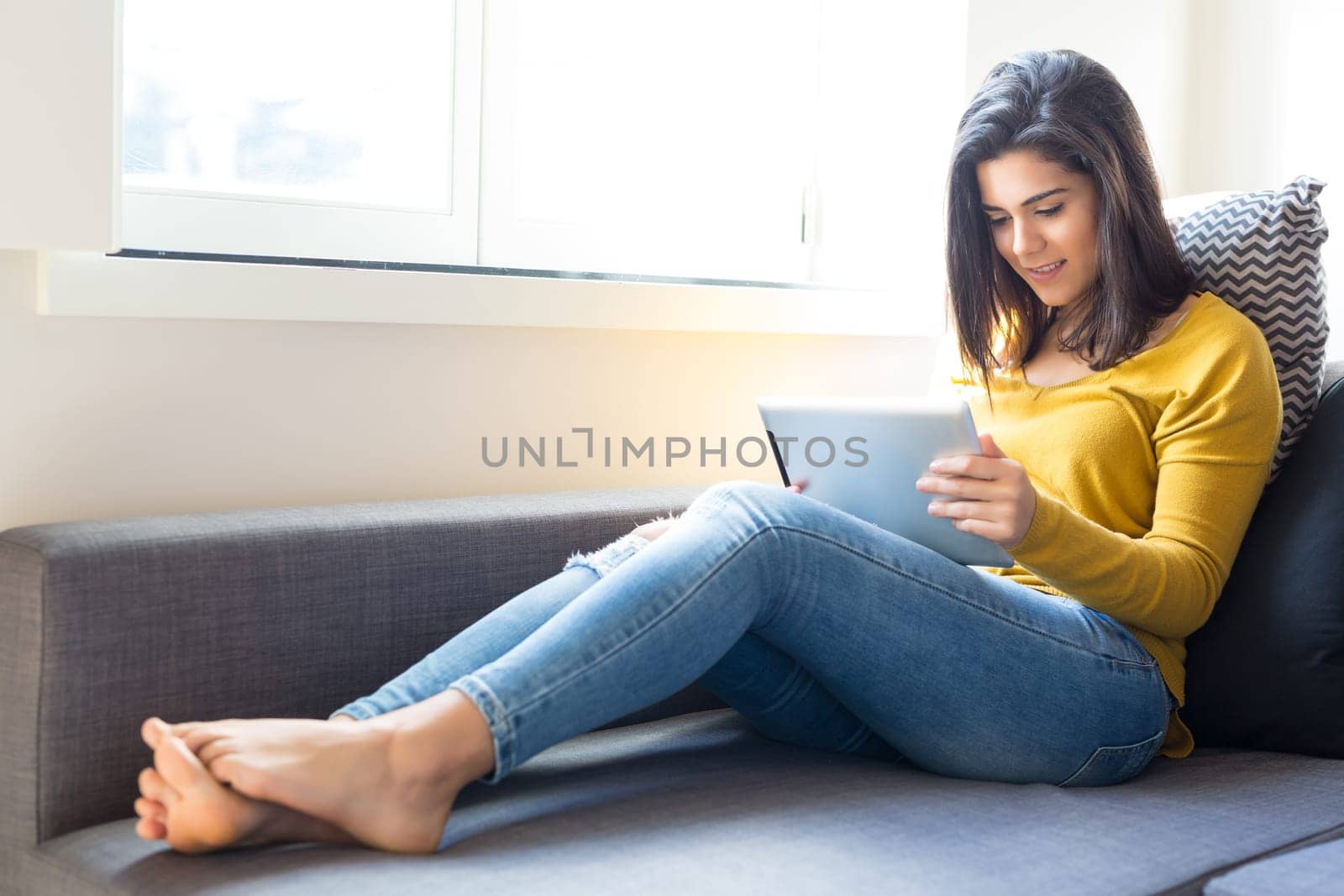 Beautiful young woman relaxing at the living room