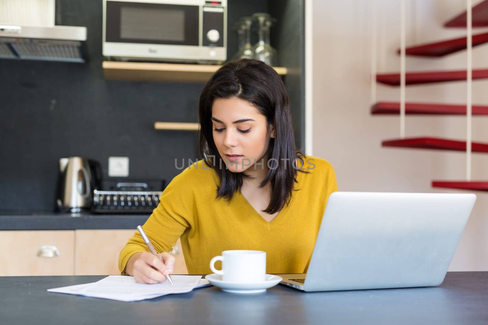 Young woman working at home in the morning