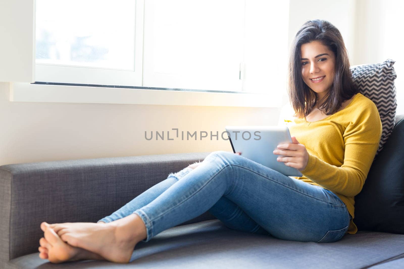 Beautiful young woman relaxing at the living room