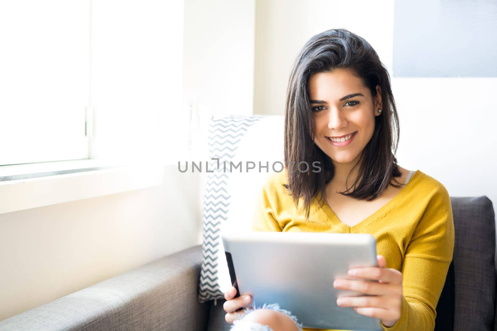 Beautiful young woman relaxing at the living room