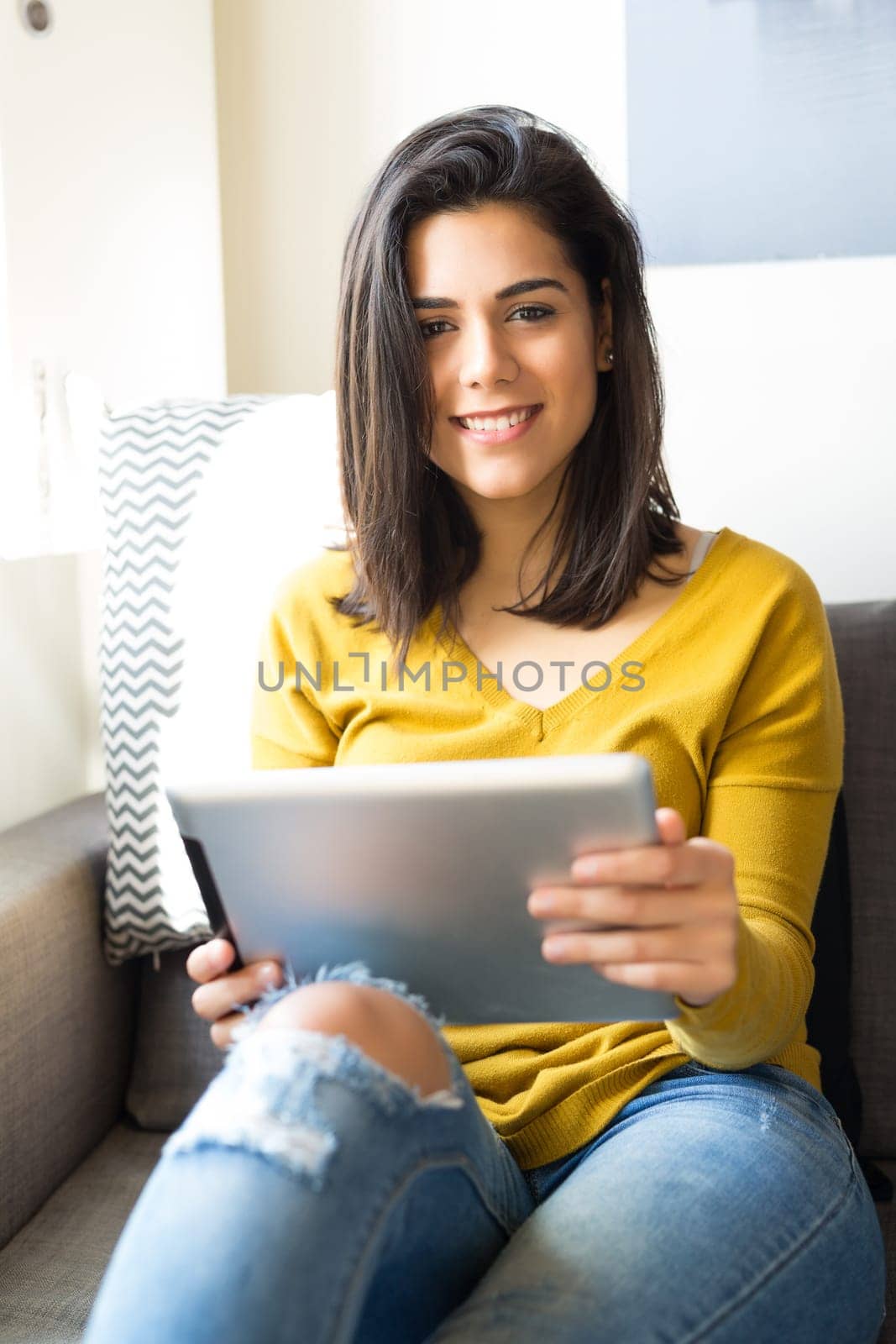 Beautiful young woman relaxing at the living room