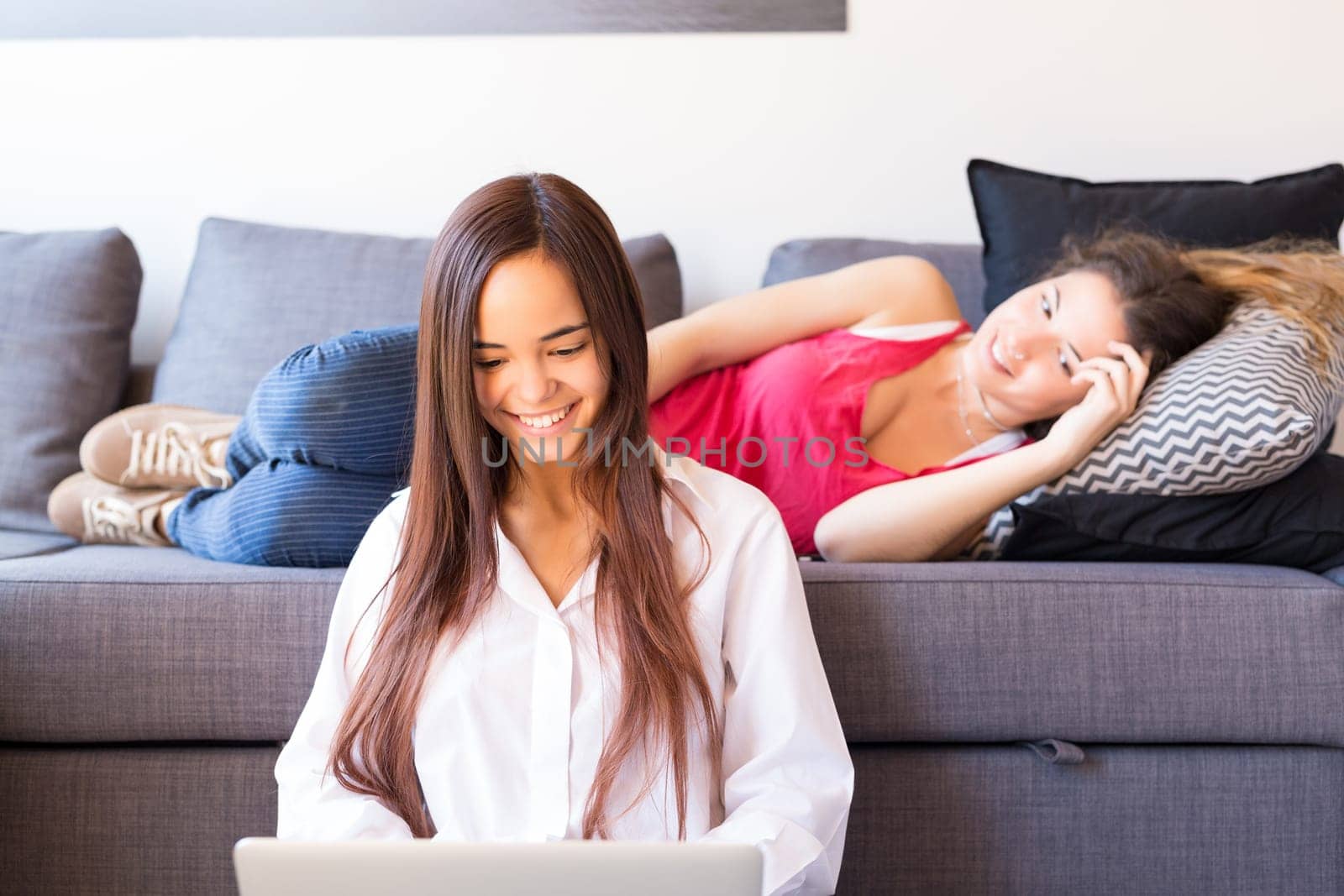 Happy friends relaxing at the living room