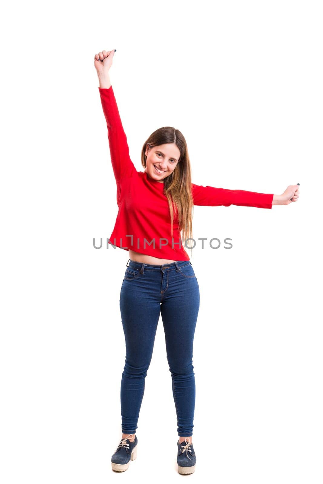 Studio shot: Happy woman with raised arms