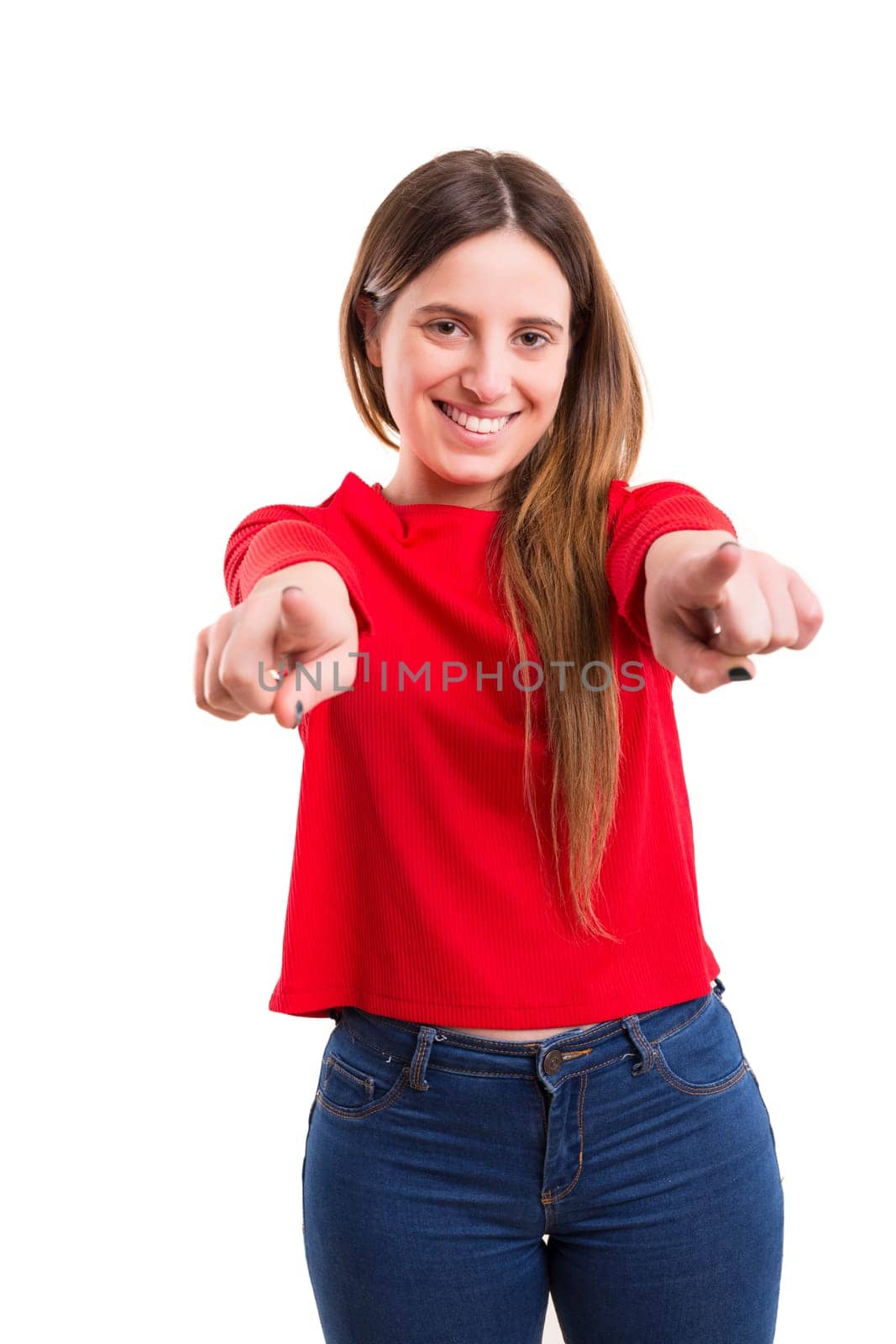 Young beautiful woman pointing at you, isolated over white