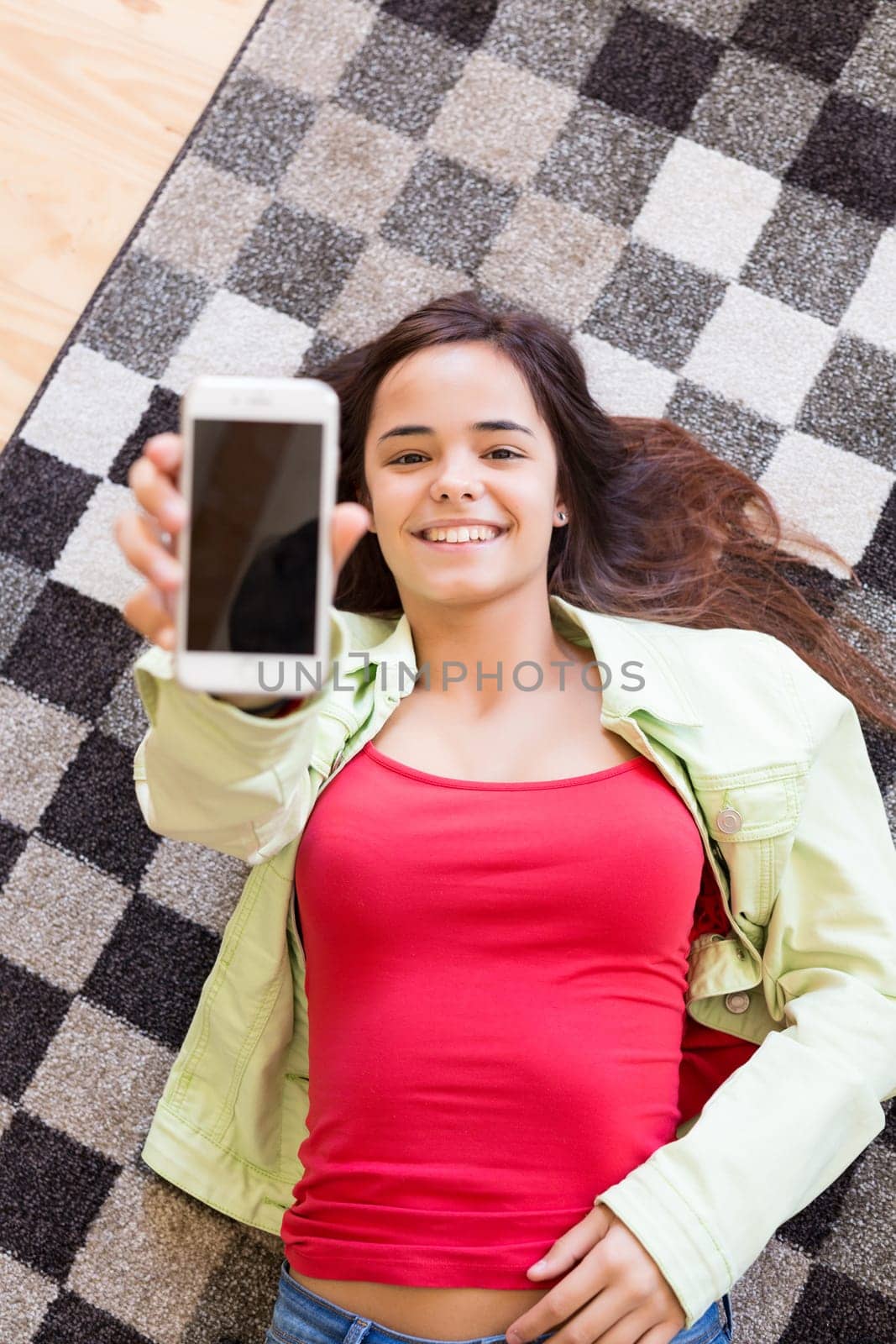 Woman updating her social networks while relaxing in the living room