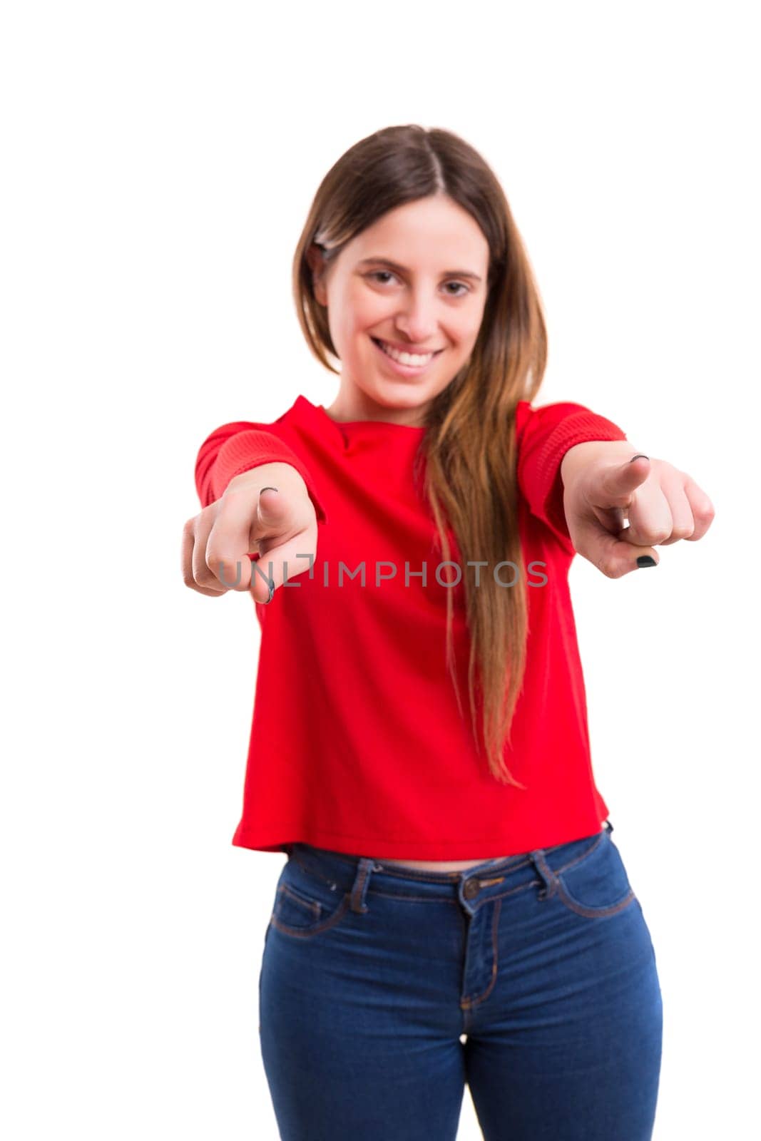 Young beautiful woman pointing at you, isolated over white