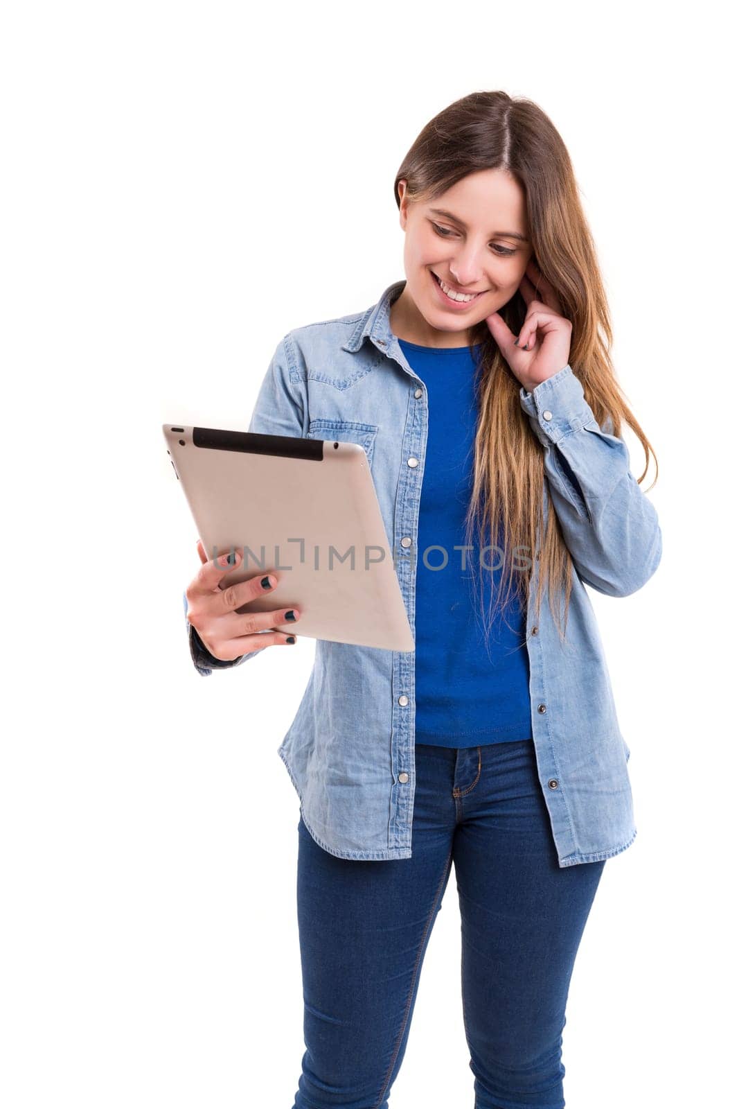 Beautiful woman relaxing with a tablet computer