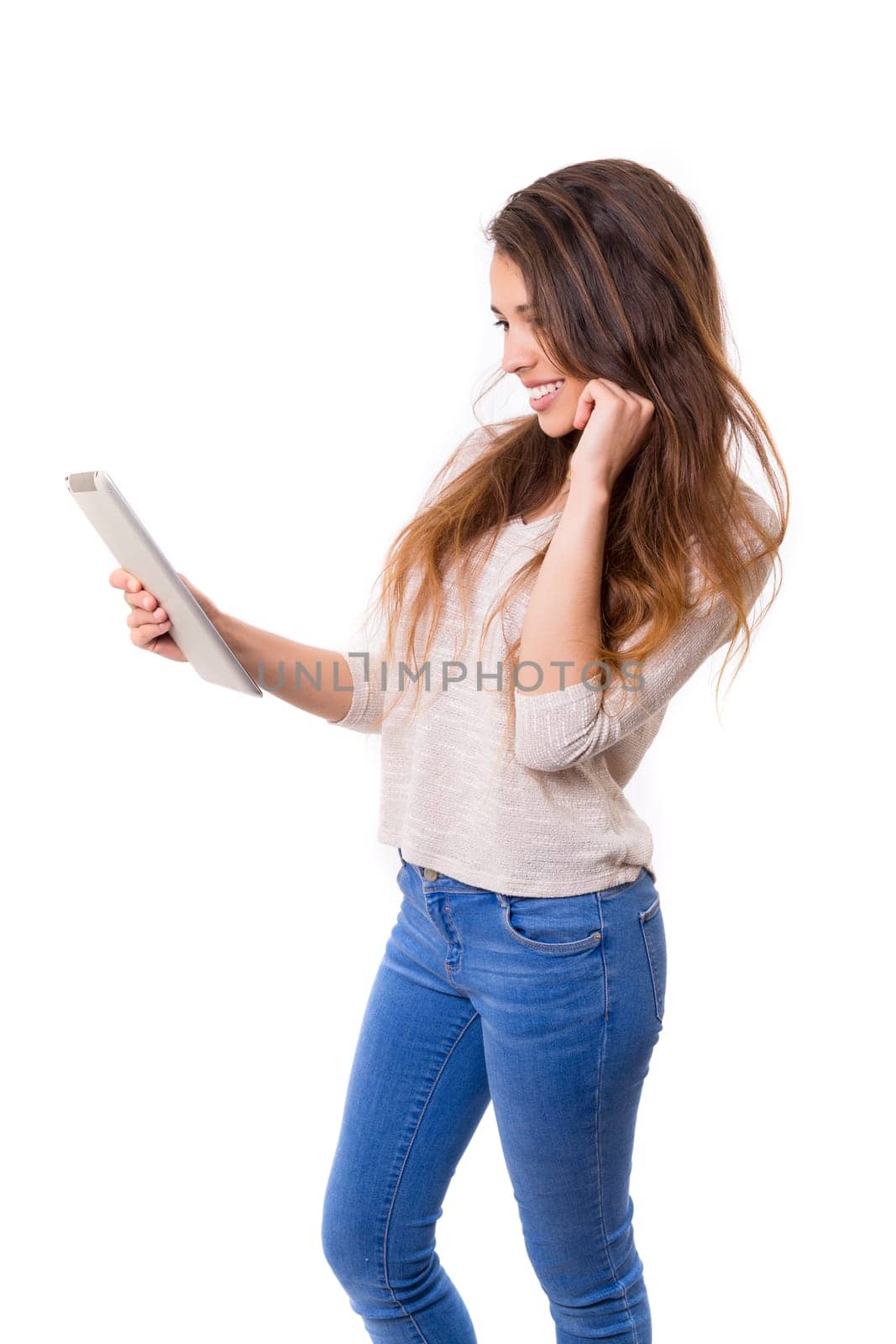 Beautiful woman relaxing with a tablet computer