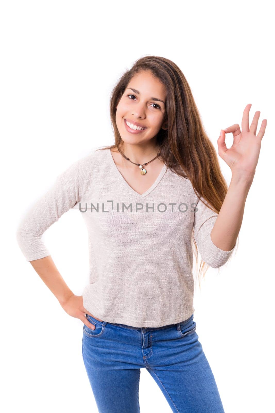Beautiful young woman signaling ok, isolated over white