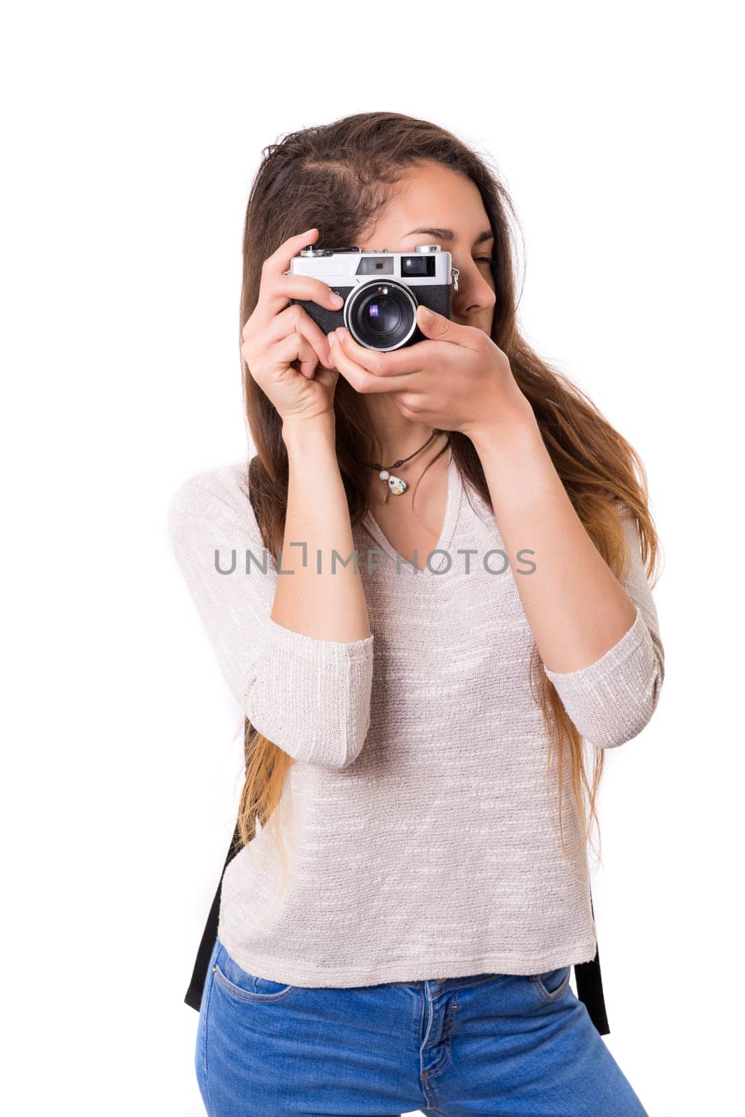 Beautiful woman holding a vintage camera, isolated over white background