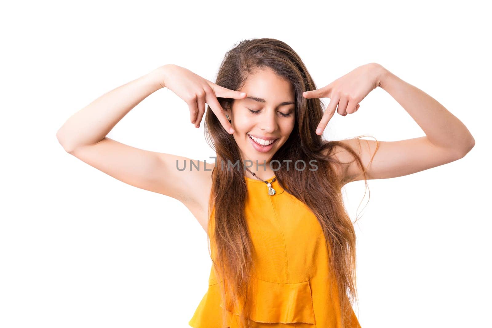 A beautiful young woman making a silly expression, isolated over white