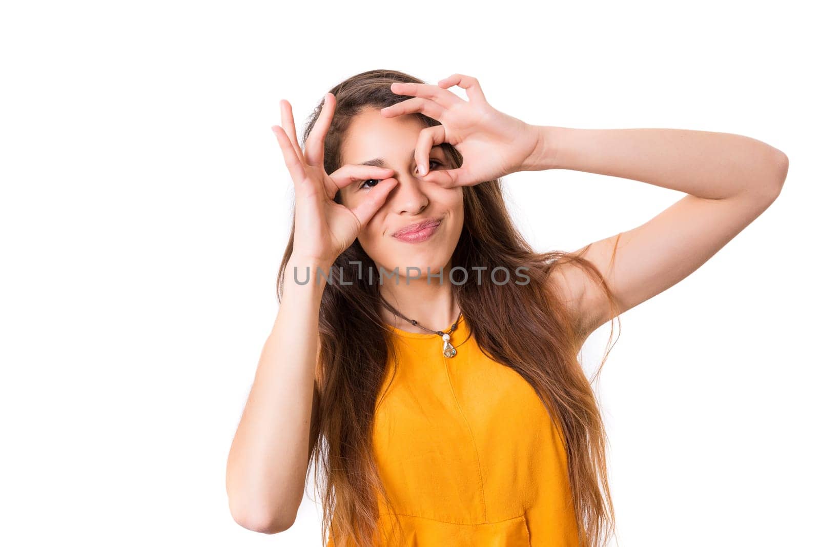 A beautiful young woman making a silly expression, isolated over white