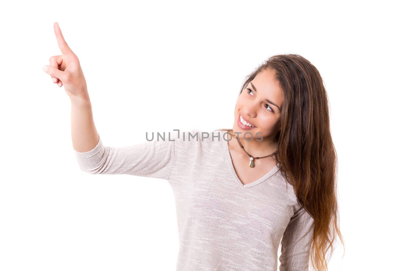 A beautiful woman pointing to something, isolated over a copy space background