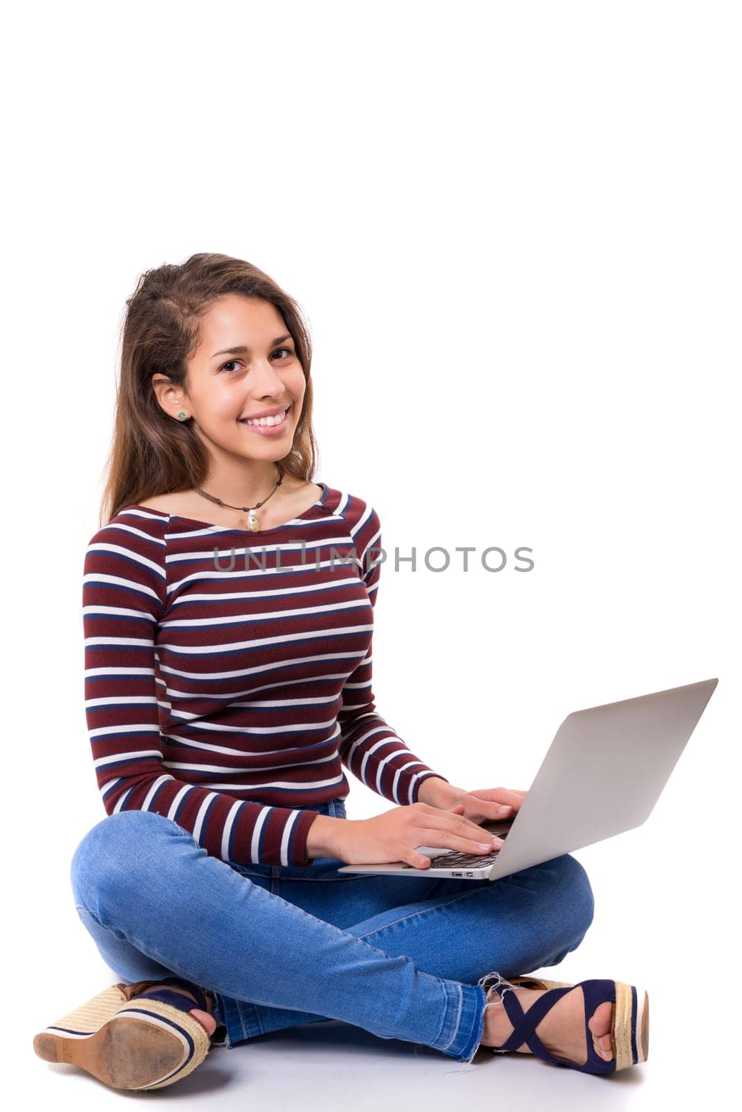 Young student working with her laptop, isolated over a white background