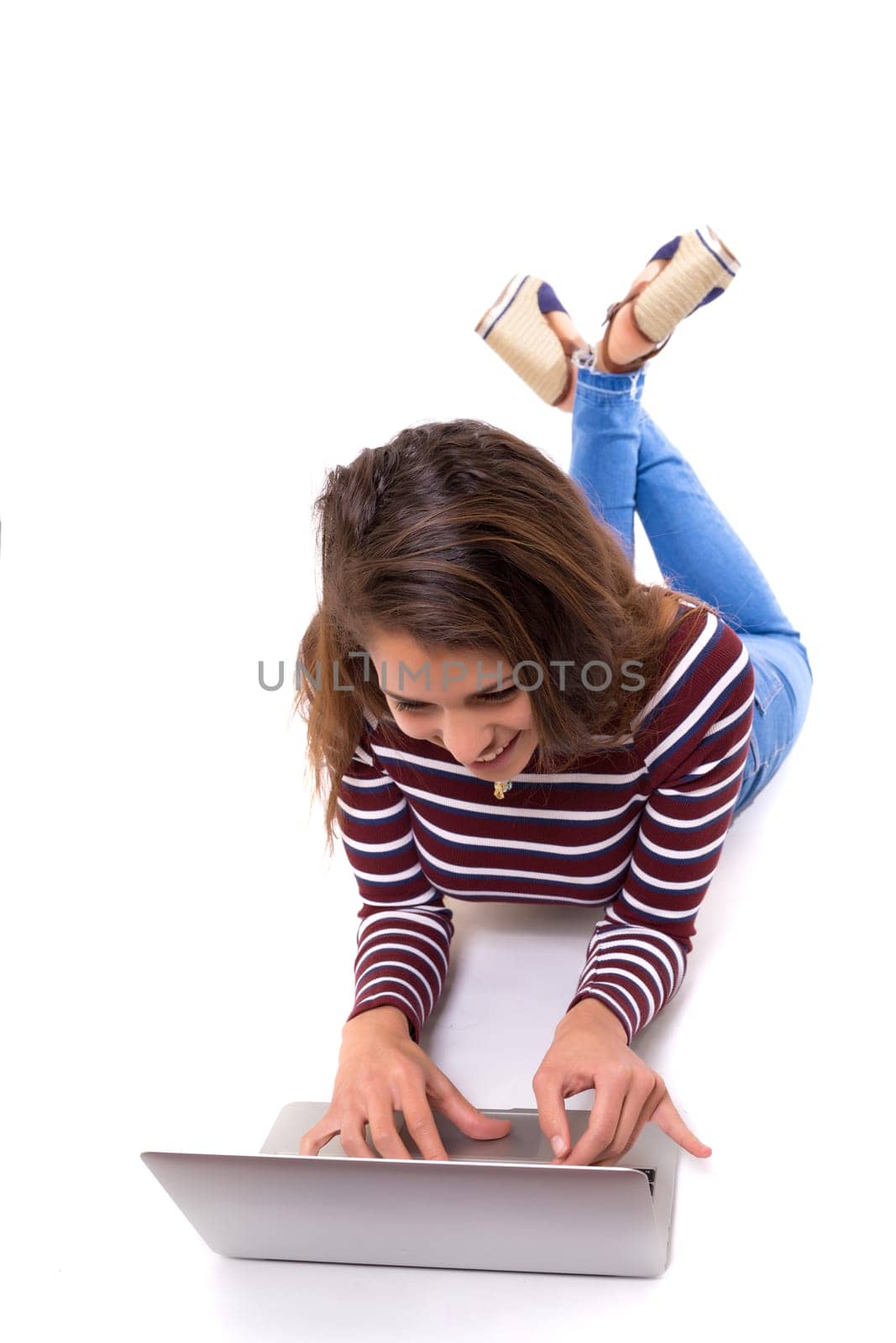Young student working with her laptop, isolated over a white background