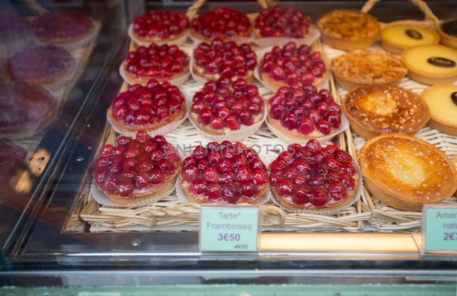 Local patiserie in Paris showing the typical french pastries: raspberry pies