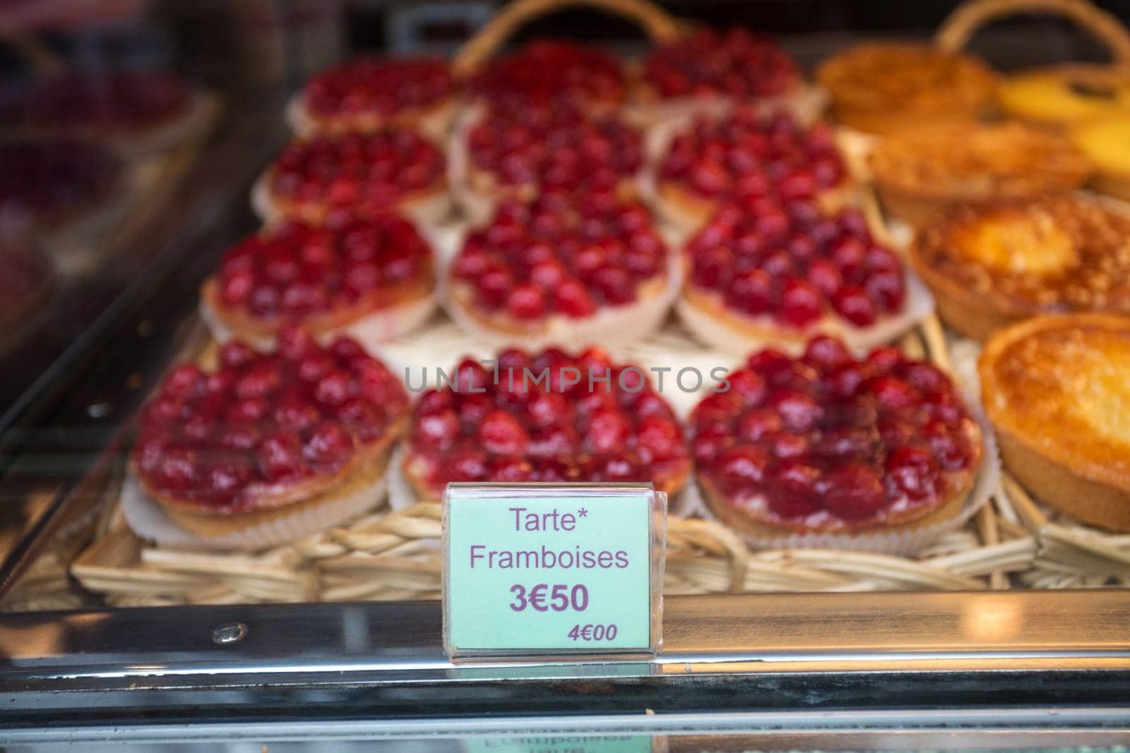 Local patiserie in Paris showing the typical french pastries: raspberry pies