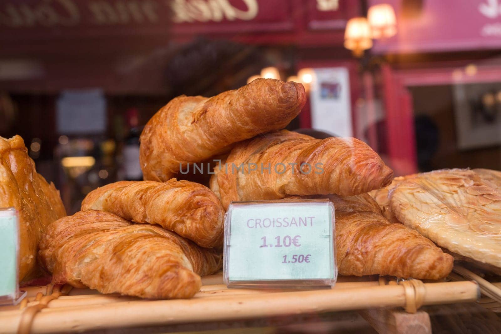 Local patiserie in Paris showing the typical french pastries: croissants