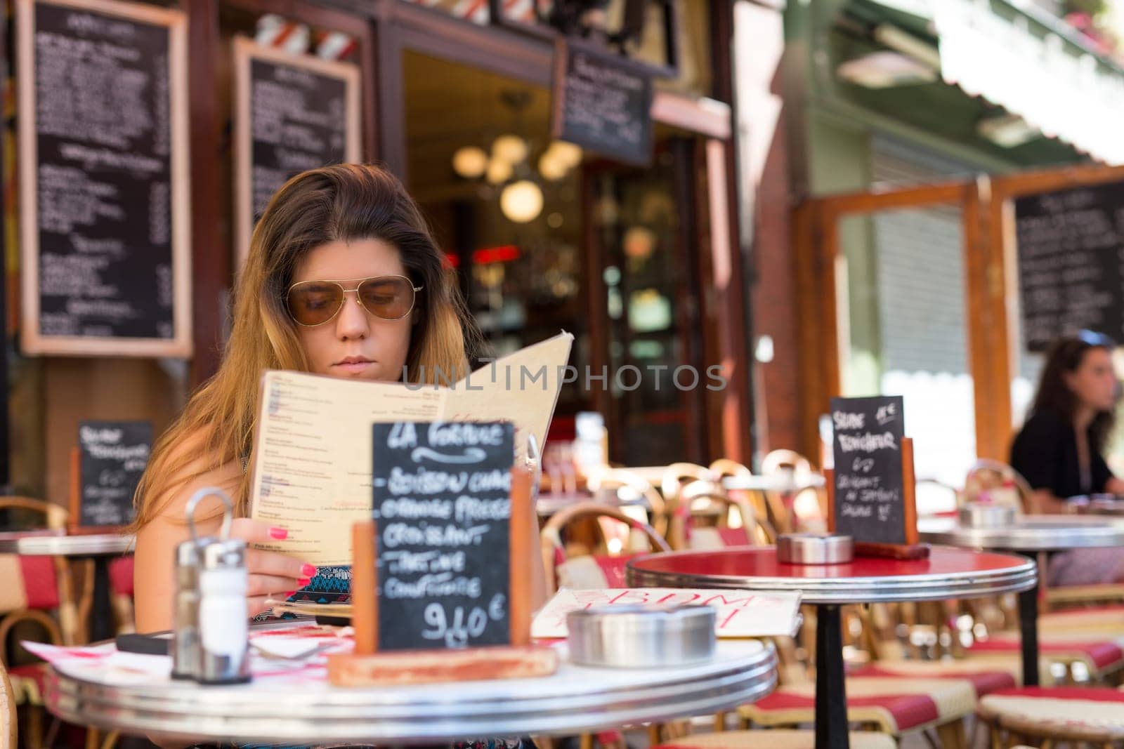 Beautiful young woman at a typical french restaurant
