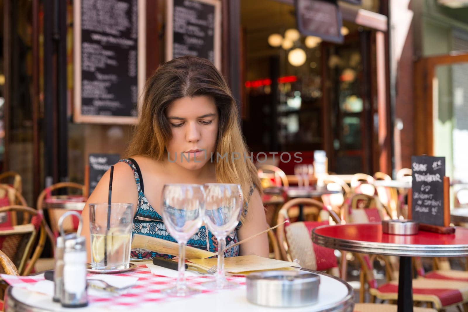 Beautiful young woman at a typical french restaurant